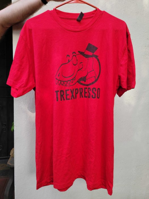 Red shirt with dinosaur head featuring monocle and top hat. Below reads "TREXPRESSO" 